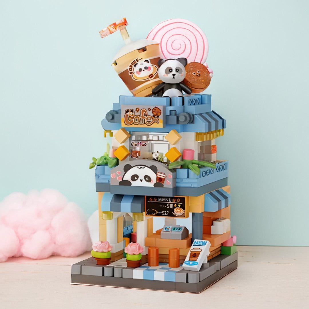 Maqueta de cafetería construida con bloques mini sobre una mesa en cuarto infantil