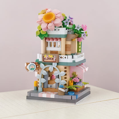Tienda de Flores en miniatura armada sobre una mesa en habitación infantil
